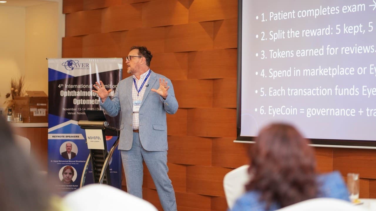 Kerry Reeves presenting the EyeCoin slide to a seated conference audience